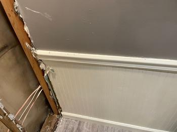 Basement wall with damage near the floor